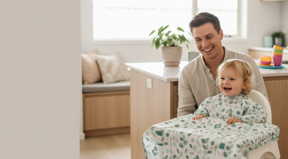 Toddler in high chair wearing MAXI bib during mealtime